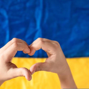 Hands,Of,A,Heart,On,The,Background,Of,The,Flag